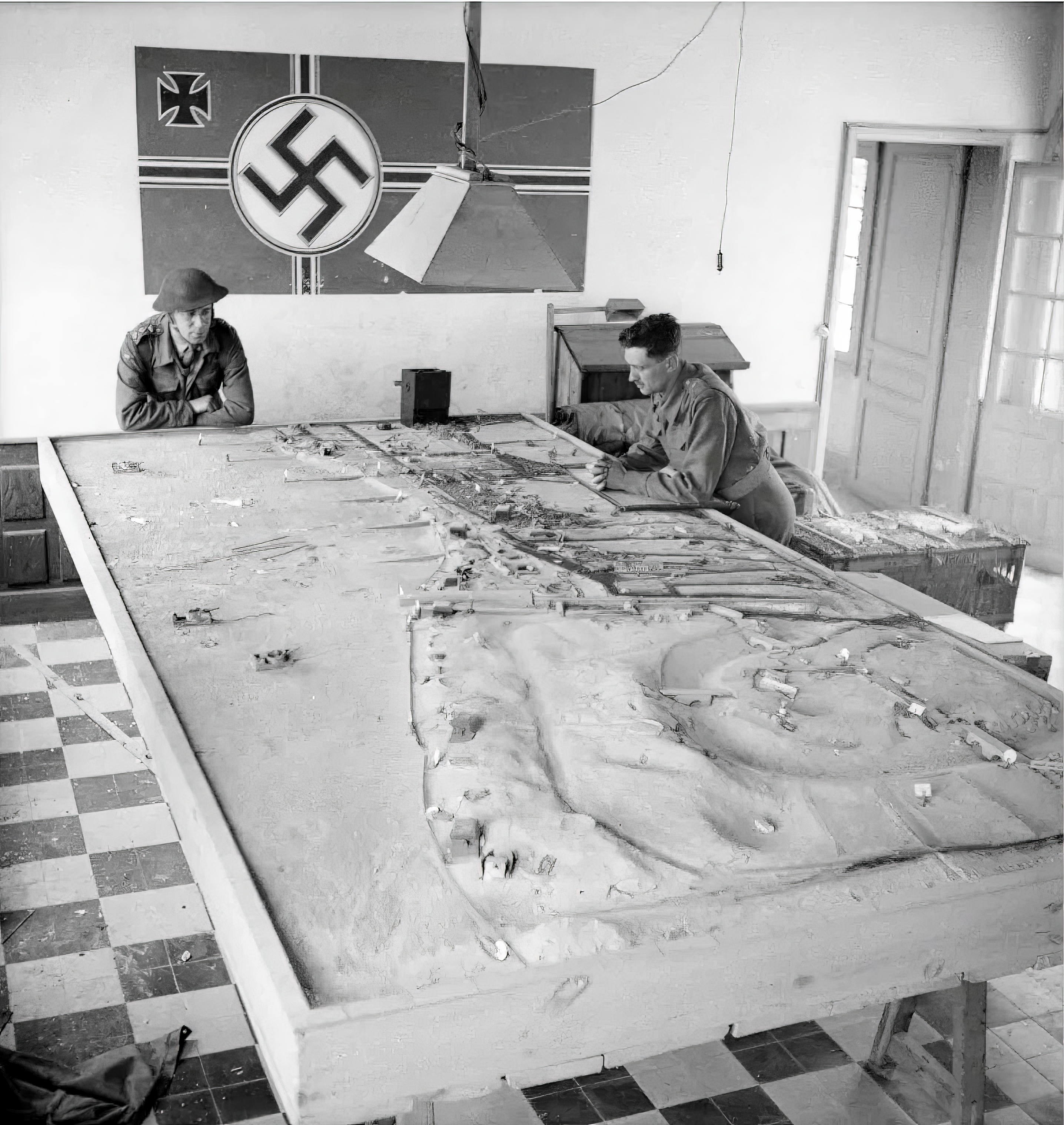 Canadian soldiers study a German plan of the beach during D-Day landing operations in Normandy on June 6, 1944.   c/o Library a
