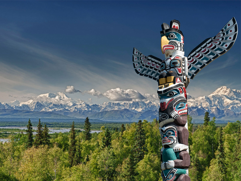 Totem pole with Mountains in BC
